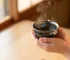 Woman Holding Handcrafted Tenmoku Tea Cup During Morning Ritual