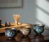 Three beautiful tenmoku tea cups showing different glaze patterns oil spot hares fur and yao bian arranged on dark wooden tea table