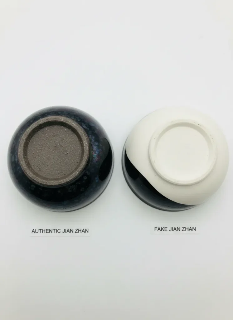How to Identify Fake Jian Zhan: Red Flags to Watch Out For 4 Side-by-side comparison of authentic Jian Zhan dark gray-brown foot ring versus fake cup with pale white base, showing clay color difference for authentication