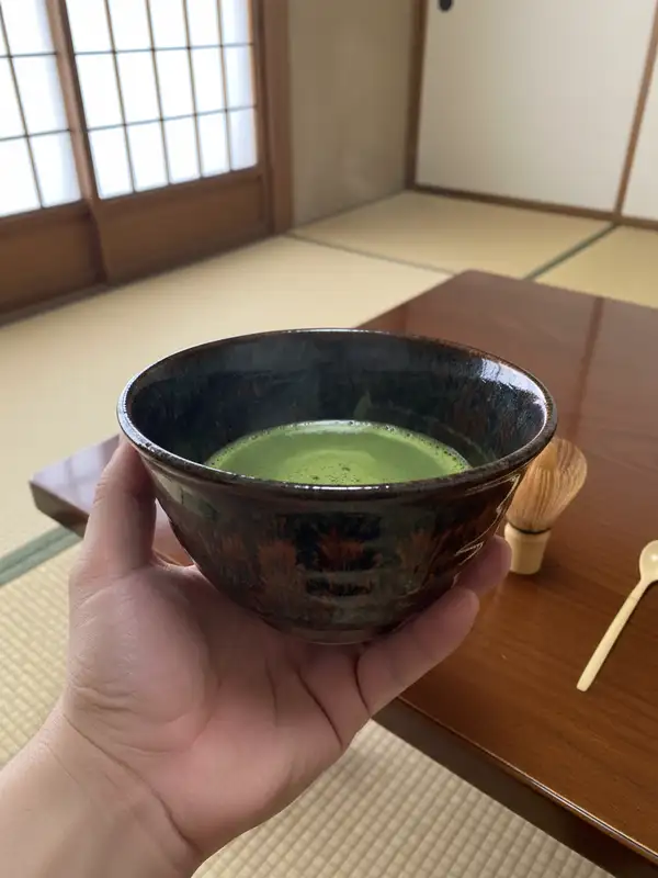 Large matcha bowl in large hand Large matcha chawan bowl cradled in large hand with full-palm grip
