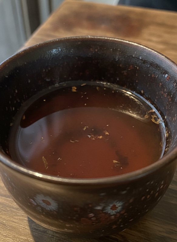 Close-up of tenmoku glaze with aged pu-erh liquor