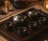 Full Tenmoku tea set featuring matching oil spot glaze on teapot, sharing pitcher, and four cups arranged on a wooden tea tray