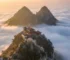 The twin peaks of Tianmu Mountain rising above a sea of clouds at dawn, showing why the mountain is called Heavens Eye