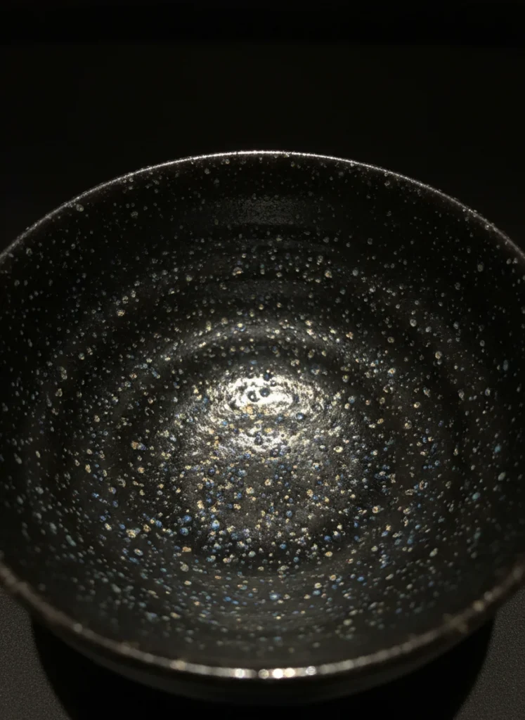 Tianmu Mountain: The Origin of the Tenmoku Name (Heaven's Eye) 5 Close-up of a Yohen Tenmoku bowl showing iridescent oil spot glaze pattern