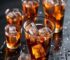 Tenmoku cup with cold brew iced tea and ice cubes on dark surface